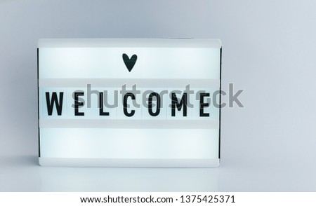 Photo of a light box with text, WELCOME, over isolated backgroud 
