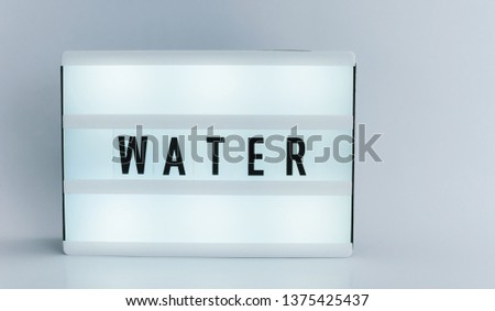 Photo of a light box with text, WATER, isolated white background 
