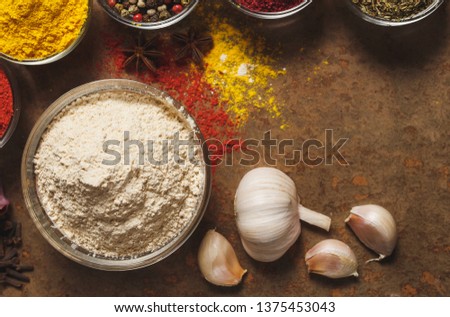 Dried Garlic. Place for text. Different types of Spices in a bowl on a stone background. The view from the top.