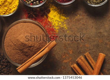 Ground Cinnamon. Place for text. Different types of Spices in a bowl on a stone background. The view from the top.