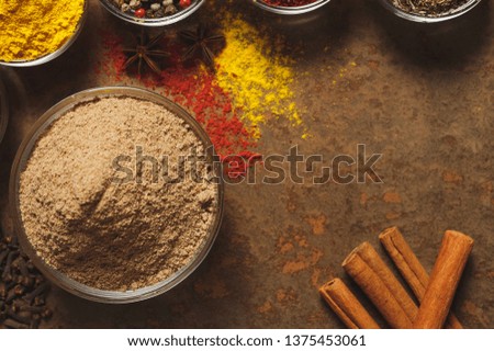 Ground Cumin . Place for text. Different types of Spices in a bowl on a stone background. The view from the top.