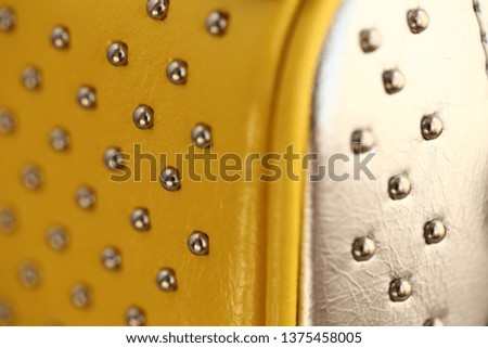 Fashionable women's yellow bag with iron rivets