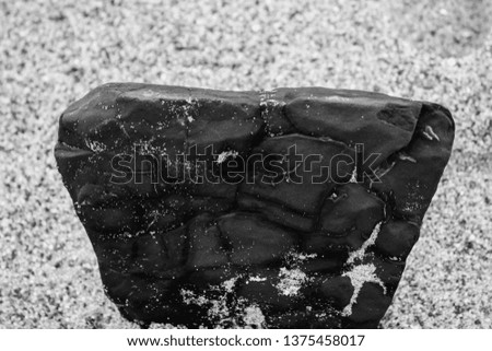 Close Up of a black rock on the beach