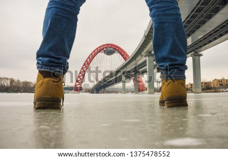 view of the red arch of the picturesque bridge between the legs, the bridge between the legs, noli on the ice Royalty-Free Stock Photo #1375478552