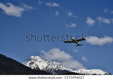 Picture of airplanes in the blue sky over Valtellina mountains