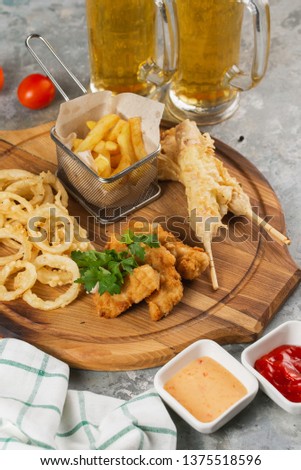 Set of fried snacks on wooden board. Beer snacks– stock image