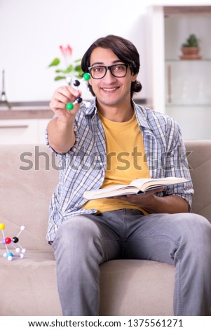 Young student physicist preparing for exam at home    