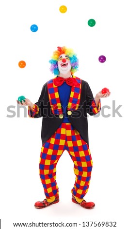 Funny clown juggling with colorful balls Royalty-Free Stock Photo #137569832