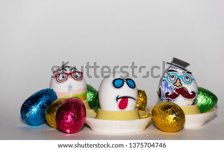 Mr. moustache, worried egg and cool Easter egg on a white background surrounded with colorfull eggs