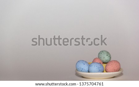 A bunch of small colorful Easter eggs on a white background