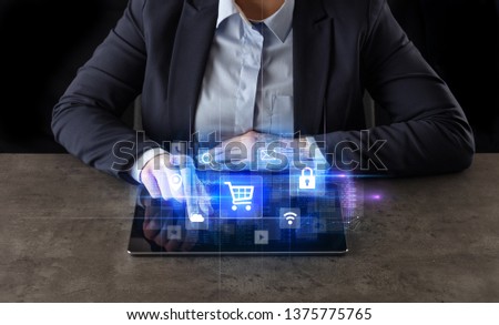 Business woman working on tablet with online ERP system concept and dark background
