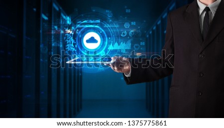 Hand holding tablet with cloud technology and dark concept