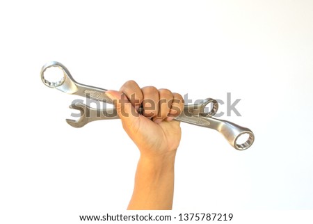 Man's hand holding wrench on a white background, isolate, with clipping path. 