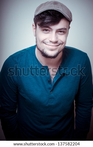 young modern stylish man with cap on vignetting background