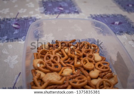 Salty snacks in the bowl on table