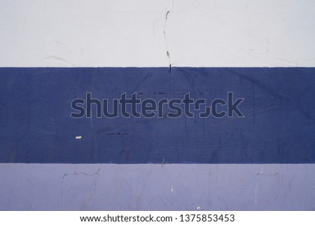 Texture of wall painted with colorful stripes pattern: white, blue, purple