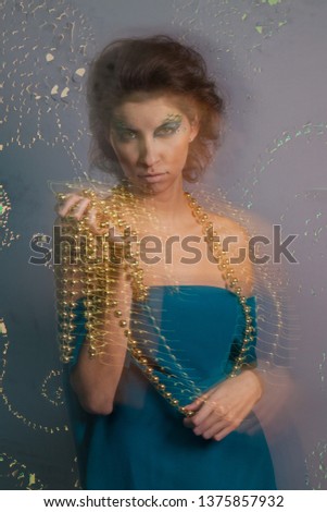 Bold image of a modern woman predator. Amazon. Temptress. Bright makeup women vamp. Long exposure photo
