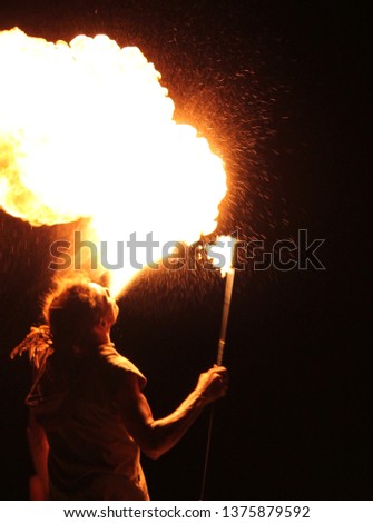 fire breather blowing big fire ball with flammable liquid stock, photo, photograph, picture, image, 