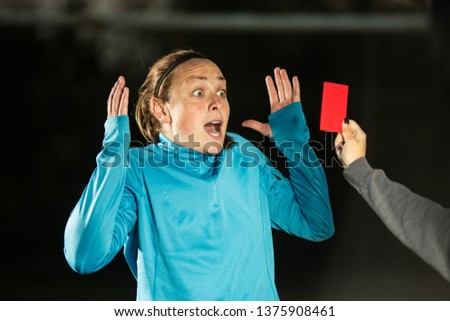 Female soccer player gets a red card and she is not happy