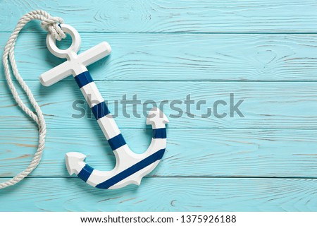 Anchor on a blue vintage wooden background. Royalty-Free Stock Photo #1375926188