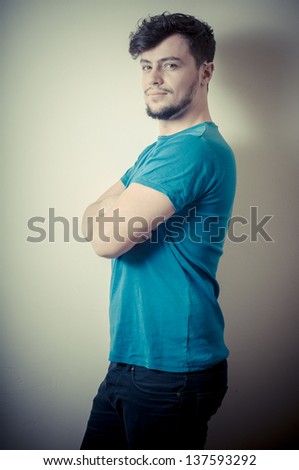 portrait of stylish young man with blue shirt on vignetting background