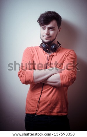 Stylish man listening to music on vignetting background