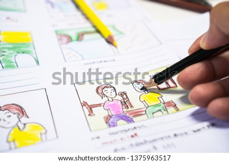 Designer drawing Story board movie video layout for pre-production, development cartoon illustration animation for process media films in form displayed script film production. Media product concept.