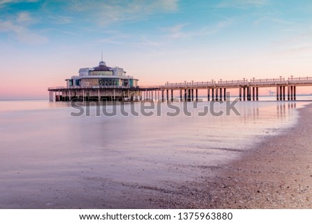 Morning sunrise in Beligum pier located in the city of Blankenberge Royalty-Free Stock Photo #1375963880