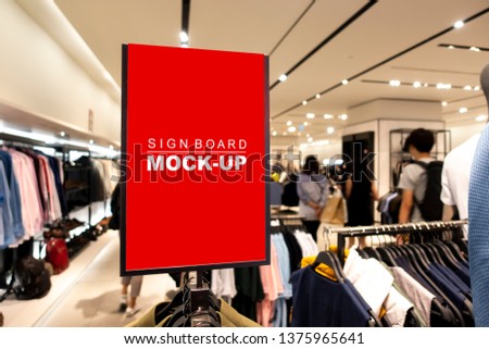 Mock up vertical blank banner or signboard on hanger  with clipping path to show promotion or discount in shop clothing, red screen empty space for insert text or advertising in shopping mall