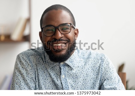Happy african american black business man hr e coach smiling talking looking at camera webcam making conference video call, online job interview, shooting blog webinar, head shot portrait