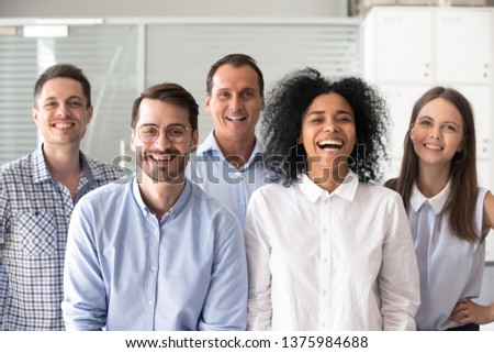 Laughing funny diverse office workers group, multiracial employees looking at camera, motivated successful business people, staff posing together in modern office, multi-ethnic colleagues portrait Royalty-Free Stock Photo #1375984688