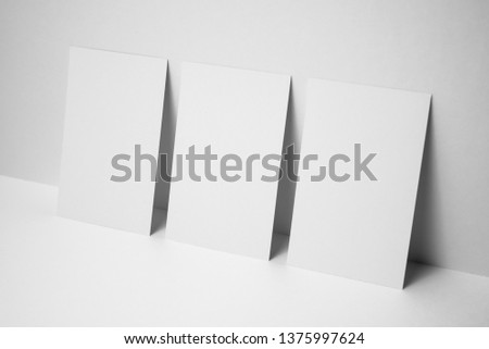 Design concept - perspective view of 3 vertical business card on white 3D space background for mockup, it's real photo, not 3D render