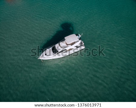 Aerial photo of an isolated luxury white  yacht design in the sea
