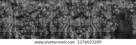 Texture of cracked concrete surface wide panorama. Gray cement with black cracks panoramic banner background.