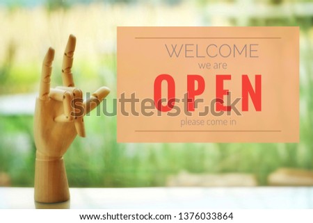 A business text ‘Open and Welcome’ on blurred of cafe or restaurant entrance background. Industry food, Cafe and restaurant idea concept.