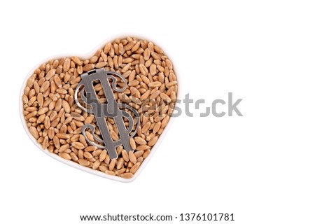 Wheat grains lie in a heart-shaped plate. US dollar symbol. Isolated on white. Copy space. The concept of monetary commodity relations and food reserves, food and currency.
