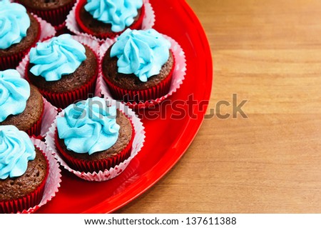 A plate of chocolate birthday cupcakes.