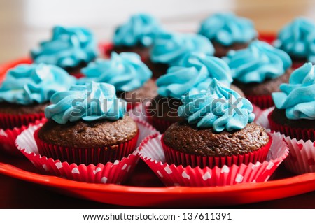 A plate of chocolate birthday cupcakes.