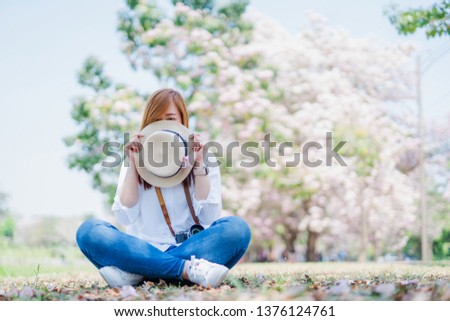 spring season with full bloom pink flower travel concept from beauty asian woman enjoy relax and see cherry blossom with soft focus background