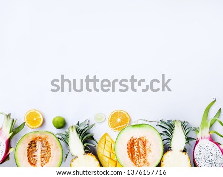fresh cut Exotic fruits tropical leaves on a white background, space for text, top view flat lay