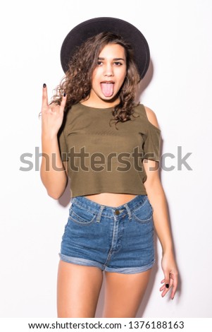 Young woman in summer clothes with funky hat with rock sign isolated on white background