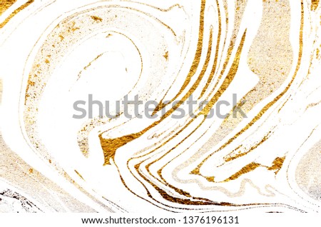 Golden swirl, artistic design. Suminagashi – the ancient art of Japanese marbling. Paper marbling is a method of aqueous surface design. White paper and gold texture. 