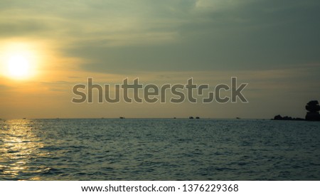 Landscape of beautiful sunset in Phu Quoc island sandy beach with colorful sky and dramatic clouds over wavy sea