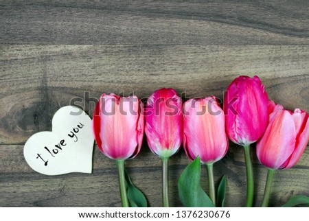 I love you. tulips on a wooden table. top view. copy spaces