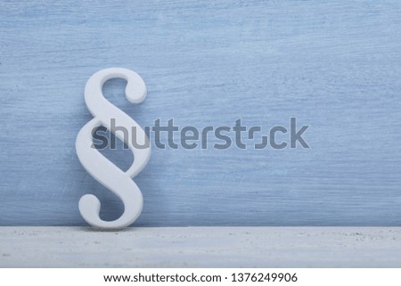 Close-up Of A Paragraph Symbol Leaning On Blue Wall
