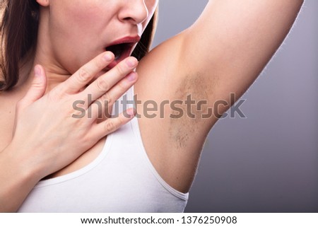 Close-up Of A Young Woman With Hairy Armpit