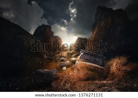4x4 off road vehicle coming out of a mud hole hazard,mud and water splash in off-road racing on mountain road. Royalty-Free Stock Photo #1376271131