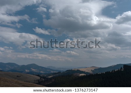 mountain views with cloudy sky and traveling tourists in the Ukrainian Carpathians