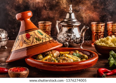 Traditional Moroccan chicken tagine with olives and salted lemons, selective focus. Royalty-Free Stock Photo #1376274005