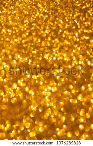 Defocused golden colour blurred background. Beautiful sparkling texture for all holidays. Selective focuse.